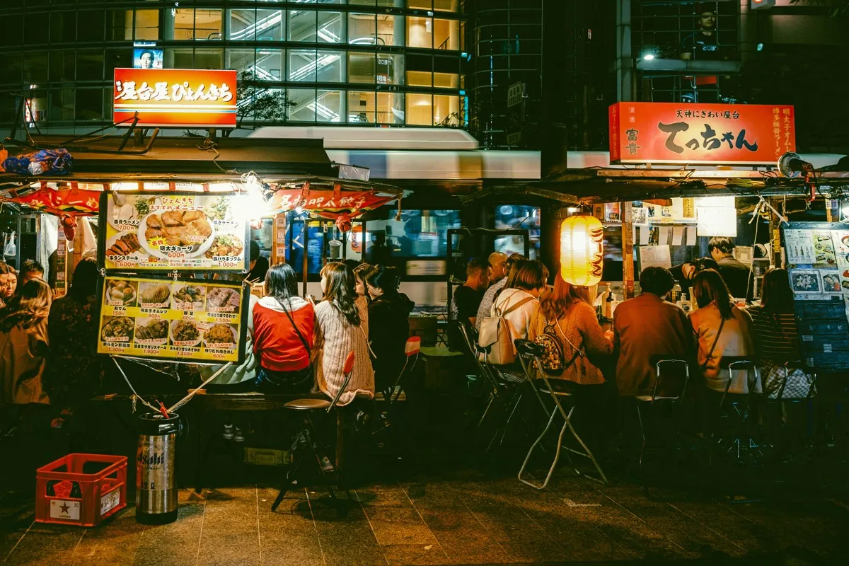 Illuminated night-time yatai by the river in Nakasu, Fukuoka
