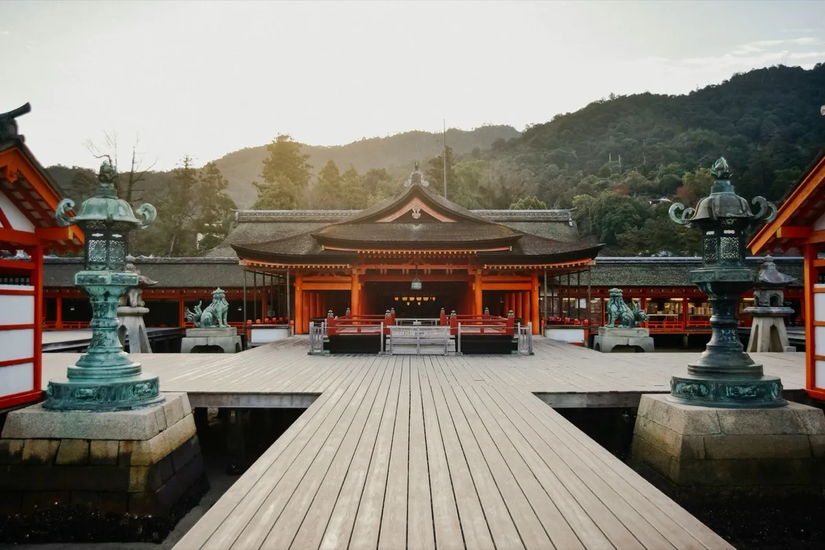 Itsukushima shrine and its wooden walkway with bronze lanterns on the island of Miyajima