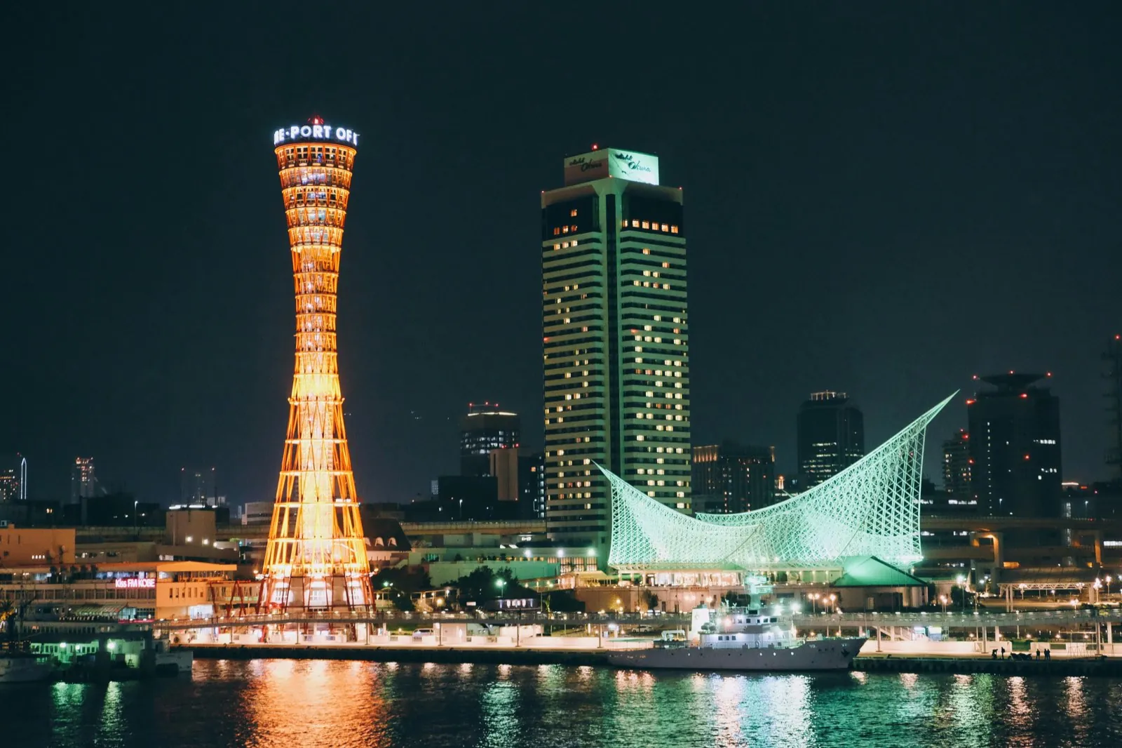 Kobe Port Tower and Maritime Museum lit up at night by the harbour