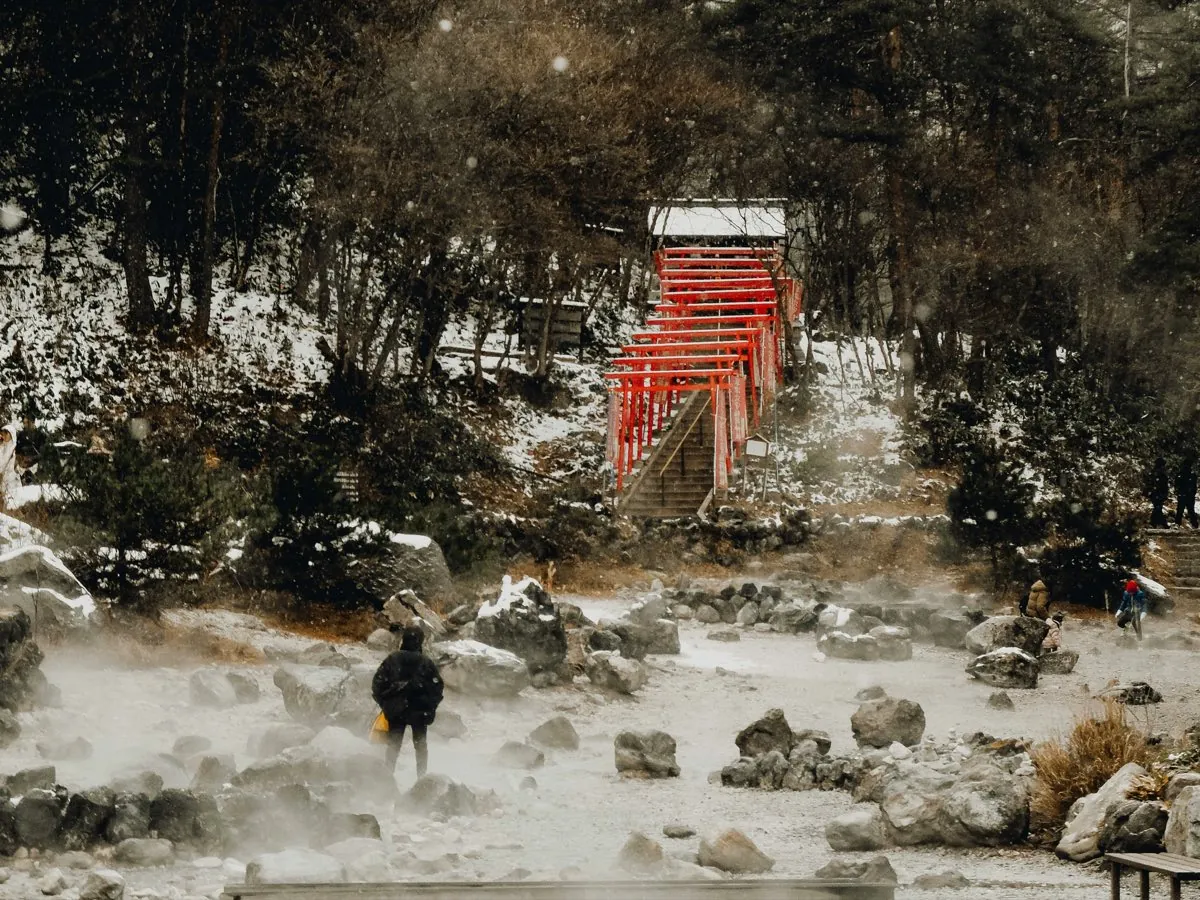 Sainokawara geothermal park with red torii and steaming springs in Kusatsu
